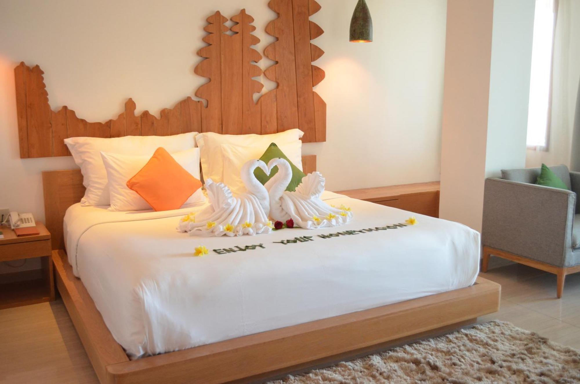 فندق نيكو بالي بينوا بيتش نوسا دوا المظهر الخارجي الصورة A bed with a towel art